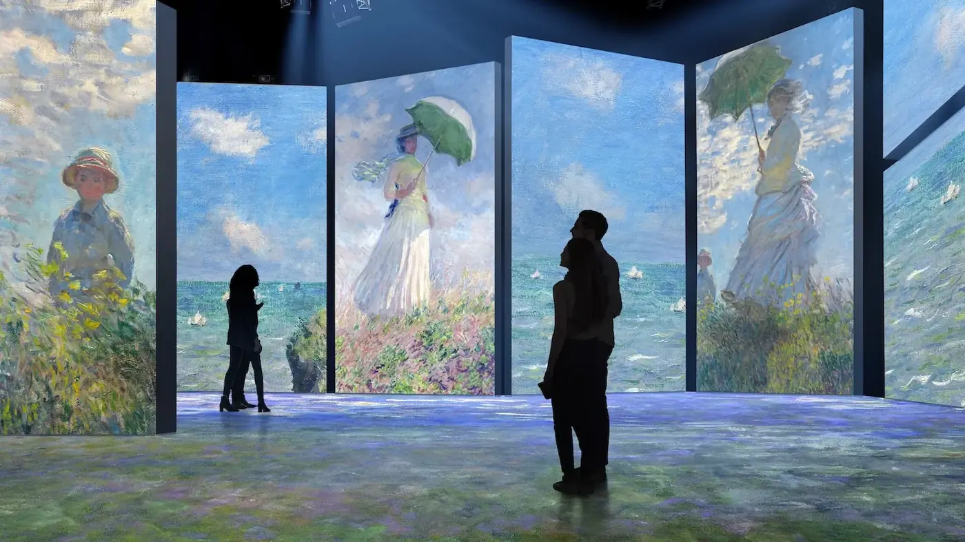 Visitors inside a wrap-around immersive projection room